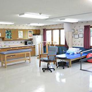 A well-equipped physical therapy room featuring a variety of exercise and rehabilitation equipment.