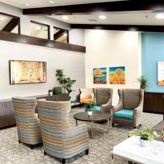 A modern lobby with comfortable seating and vibrant artwork.