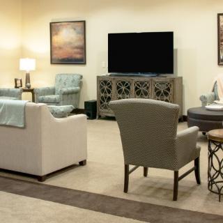 A cozy living room with comfortable seating and a large TV.