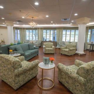 A spacious living room with comfortable seating arrangements and elegant decor.