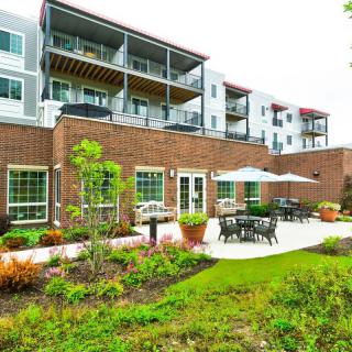 Modern apartment building with a landscaped patio area.