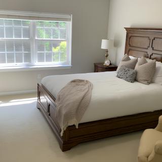 A cozy bedroom with a large window letting in natural light.