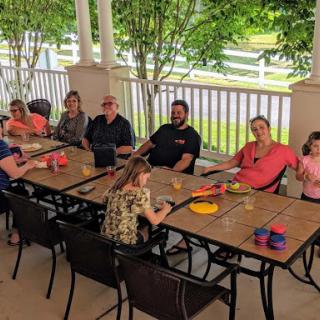 A joyful family gathering outdoors with kids and adults enjoying their time together.