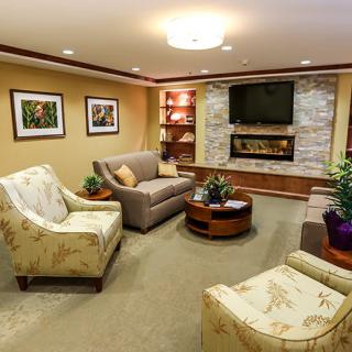 A cozy living room with comfortable seating, a modern fireplace, and tasteful decor.