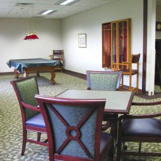 A recreational room with a pool table and seating arrangement.