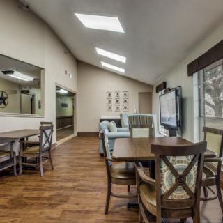 A modern living and dining area with skylights and wooden flooring.