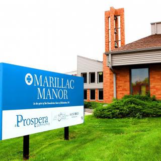 Exterior view of Marillac Manor with a prominent sign and manicured lawn.