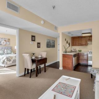 Cozy apartment with an open layout featuring a dining area, kitchen, and adjacent bedroom.