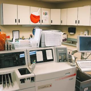 A view of a clinical laboratory filled with various medical testing equipment.