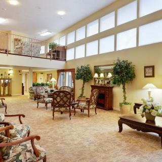 A spacious hotel lobby with elegant furniture and warm lighting.
