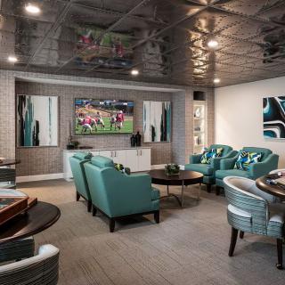 A modern living room with a home theater setup and stylish seating arrangement.