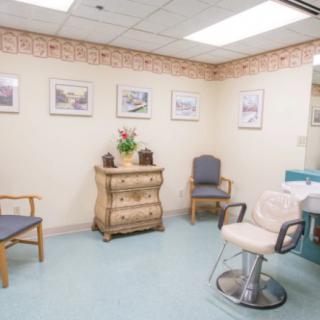 A cozy hair salon interior with chairs and decor.
