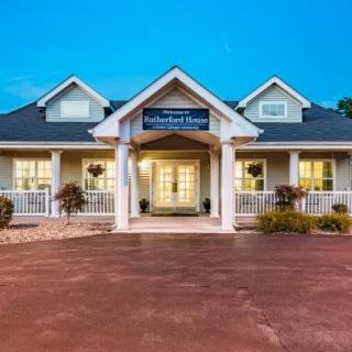 A charming residential house with a front porch and well-lit entrance.