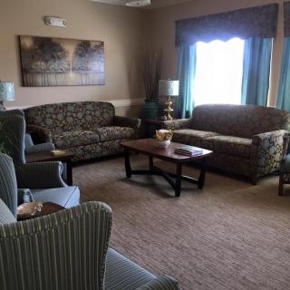 A cozy living room with two sofas, armchairs, and a coffee table.