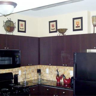 A modern kitchen with dark wood cabinets and stylish decor.