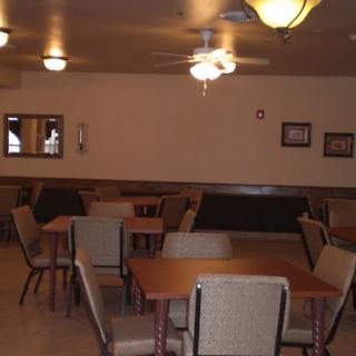 A spacious dining area with tables and chairs arranged for guests.