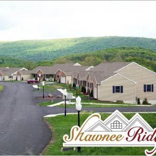 A scenic view of the Shawnee Ridge housing community nestled in a mountainous landscape.