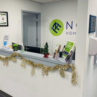 A modern office reception area decorated with holiday accents.