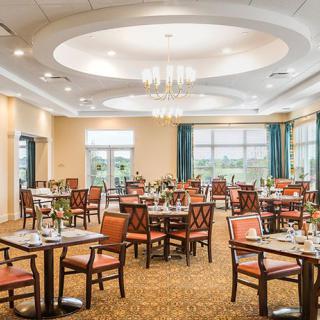 A spacious restaurant dining area with elegant furnishings and large windows.