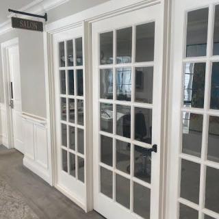 A modern office interior featuring white glass doors.
