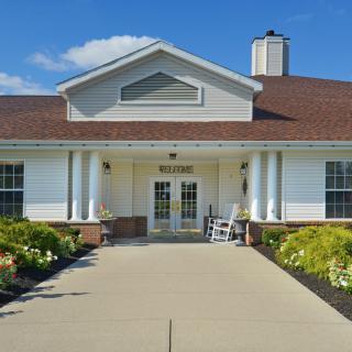 A residential building with a welcoming entrance and neatly landscaped surroundings.