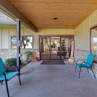 An inviting entrance with outdoor seating and decorative items.