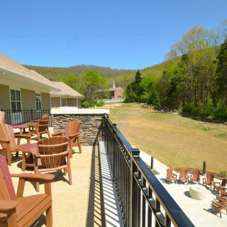 A serene balcony overlooking a lush landscape with outdoor seating.