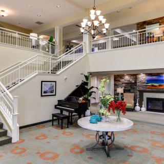 Elegant lobby with a grand staircase and beautiful decorations.