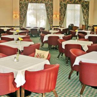 An elegant restaurant dining area with neatly arranged tables and chairs.
