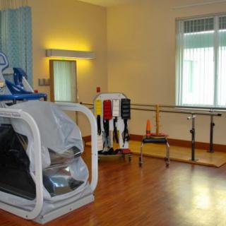 A therapy room equipped with rehabilitation and exercise equipment.