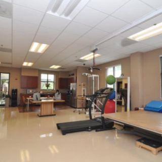 A well-equipped fitness center featuring exercise machines and a spacious workout area.
