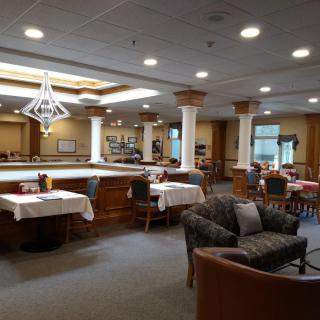 Spacious restaurant interior with tables, chairs, and cozy seating.