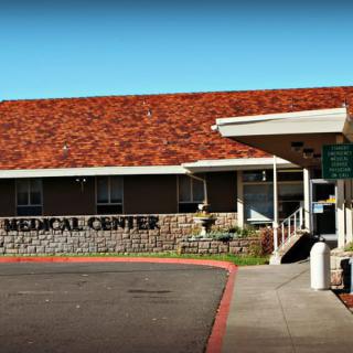 Entrance of a medical center with distinctive architectural features.