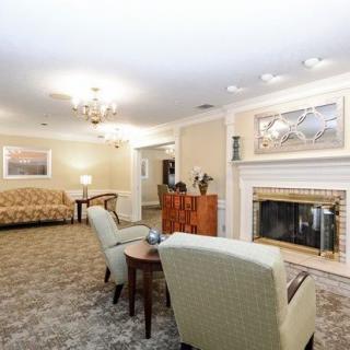 A cozy living room featuring a fireplace, comfortable seating, and elegant decor.