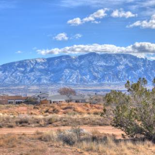 A stunning view of a mountainous landscape under a clear blue sky.