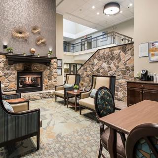 A cozy living room with a fireplace, seating area, and decorative elements.