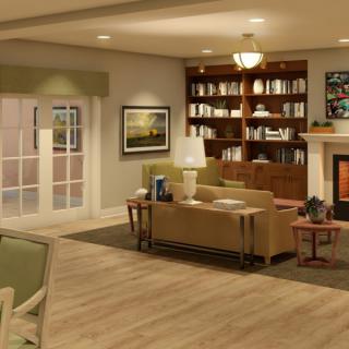 A cozy living room with a modern design, featuring a sofa, fireplace, bookshelf, and wood flooring.