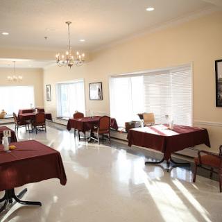 A bright and inviting dining area featuring neatly arranged tables and chairs.