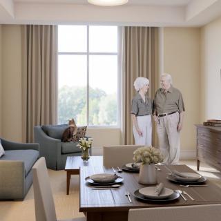An elegantly furnished living room with seniors standing near a window.