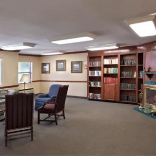 A cozy library corner with bookshelves and comfortable seating.