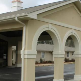 An exterior view of a building featuring arched entrances.