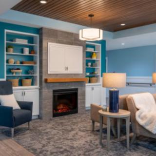 A modern and cozy living room with a stylish fireplace and built-in shelves.