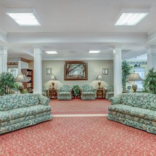 A hotel lobby featuring sofas and armchairs with decorative elements.