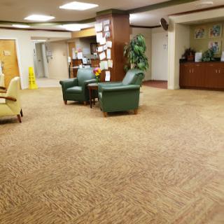 A spacious lobby area with green seating and a welcoming atmosphere.