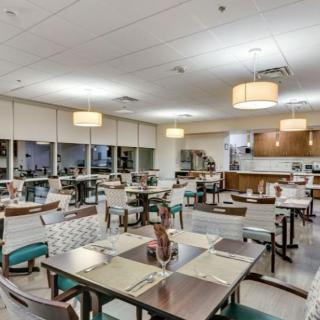 Modern dining area with neatly arranged tables and chairs.