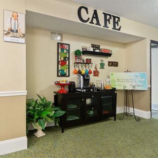 A cozy cafe setup with a coffee station, decor, and menu board.