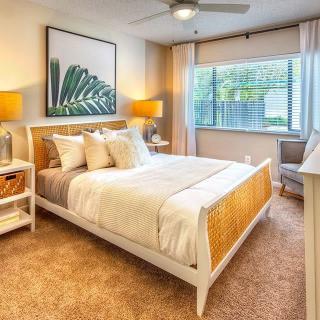 A cozy and modern bedroom with stylish decor and natural light.