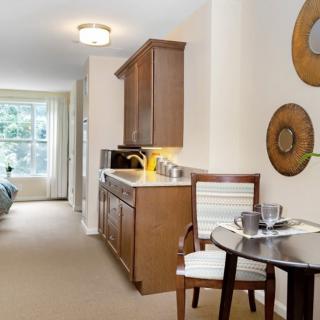 A modern interior with a kitchen and dining area featuring wooden cabinets and contemporary decor.