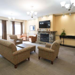A cozy living room with comfortable seating and a fireplace.