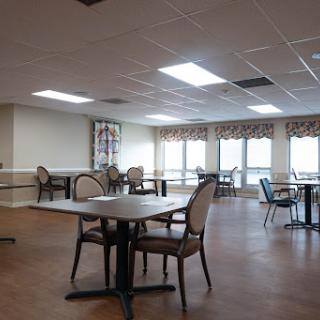 A spacious and well-lit dining area with tables and chairs, ready for guests.